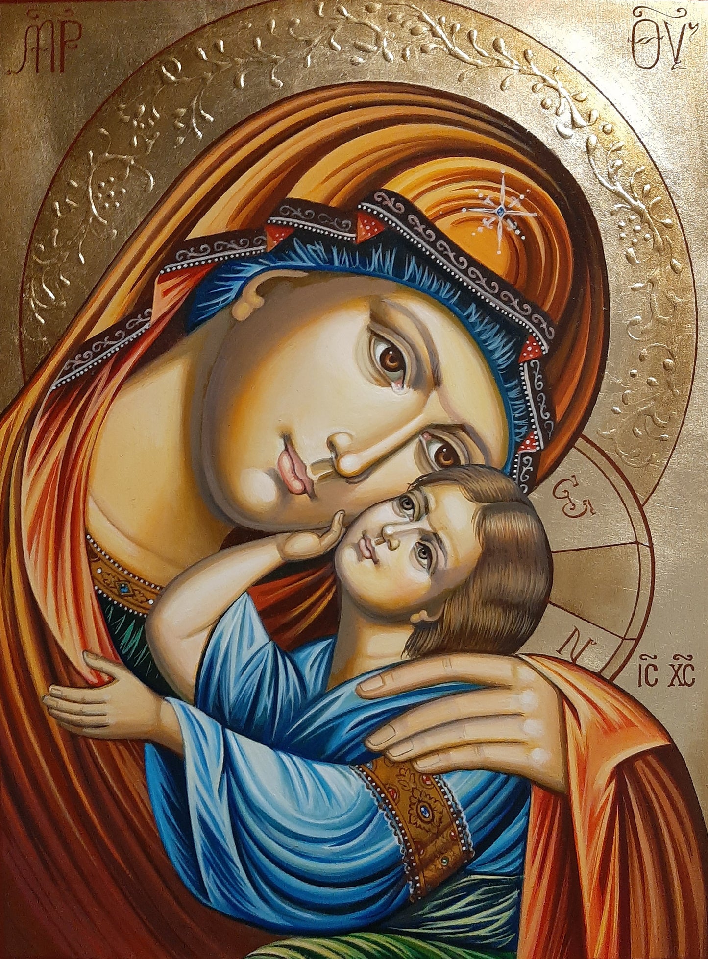 Orthodox icon of the Virgin Mary tenderly embracing the Christ Child, symbolizing miraculous affection and divine love.