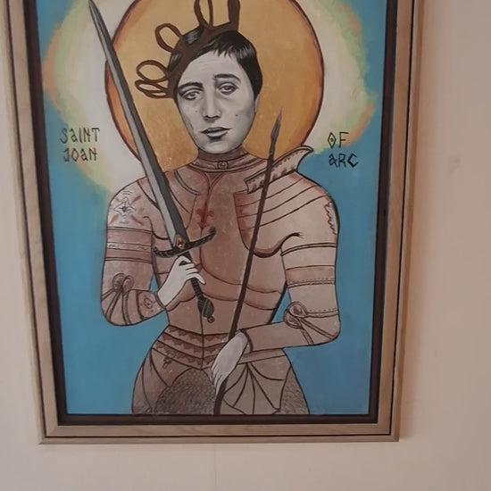 Video showing the creation of a handmade Joan of Arc icon, featuring gold leaf halo application, silver armor painting, and detailed brushwork inspired by Falconetti’s silent film portrayal, blending Orthodox technique with emotional cinematic dep