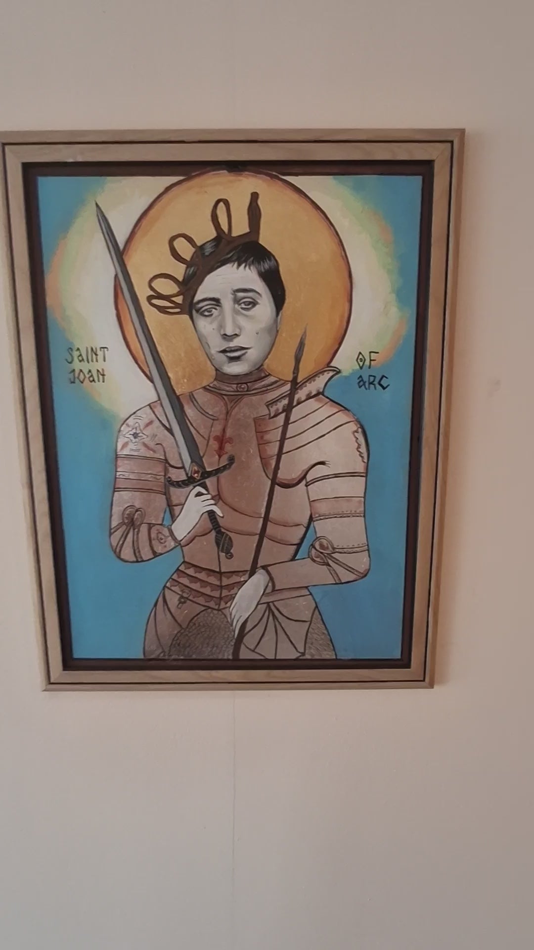 Video showing the creation of a handmade Joan of Arc icon, featuring gold leaf halo application, silver armor painting, and detailed brushwork inspired by Falconetti’s silent film portrayal, blending Orthodox technique with emotional cinematic dep