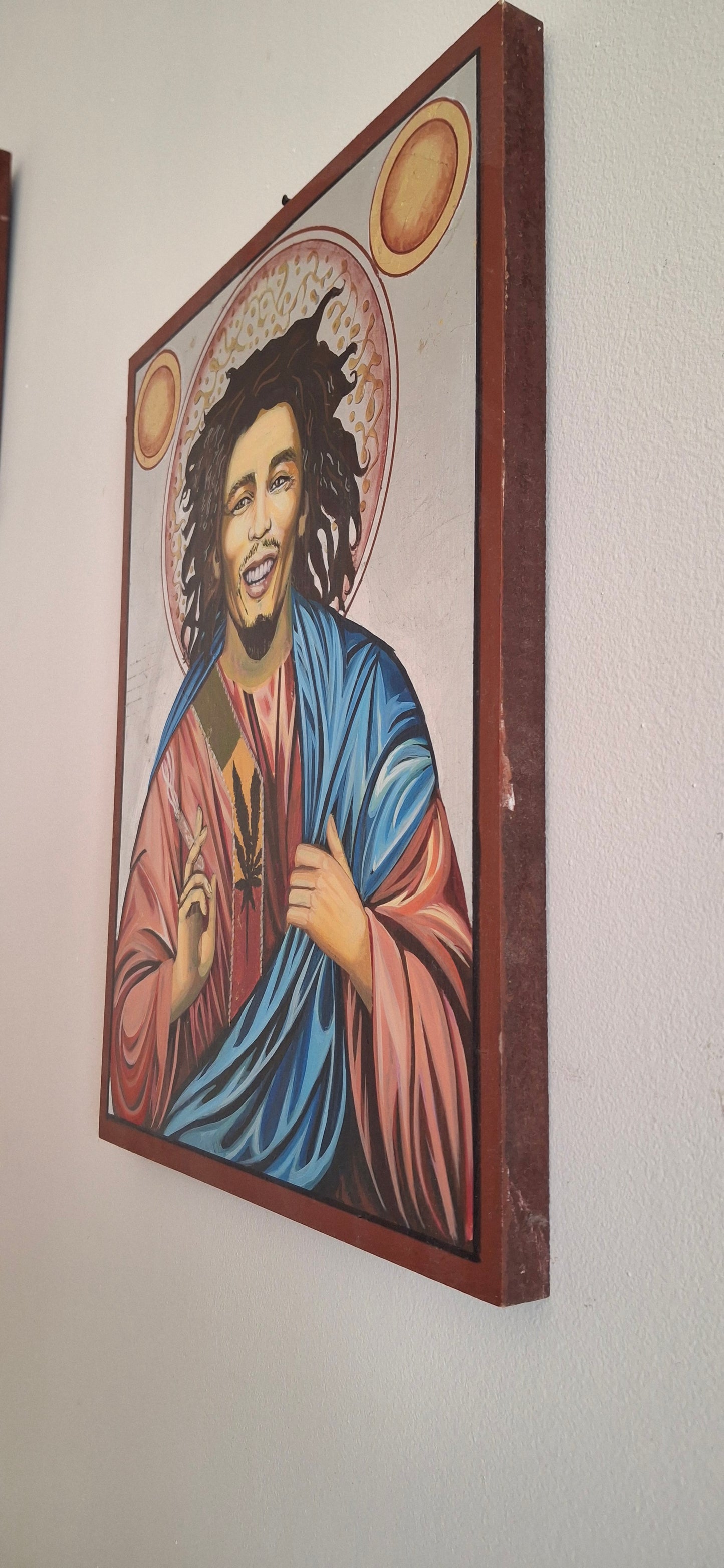 Reggae saint deconstructed — Bob Marley levitating with torn robes of vinyl, Rastafarian fire bursting from his ribcage