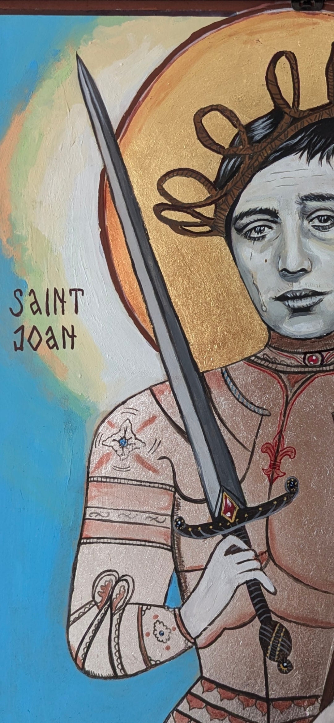 Orthodox-style icon painting of Joan of Arc, showing emotional intensity, handcrafted brushwork, real gold and silver finishes, and minimalist background with symbolic depth