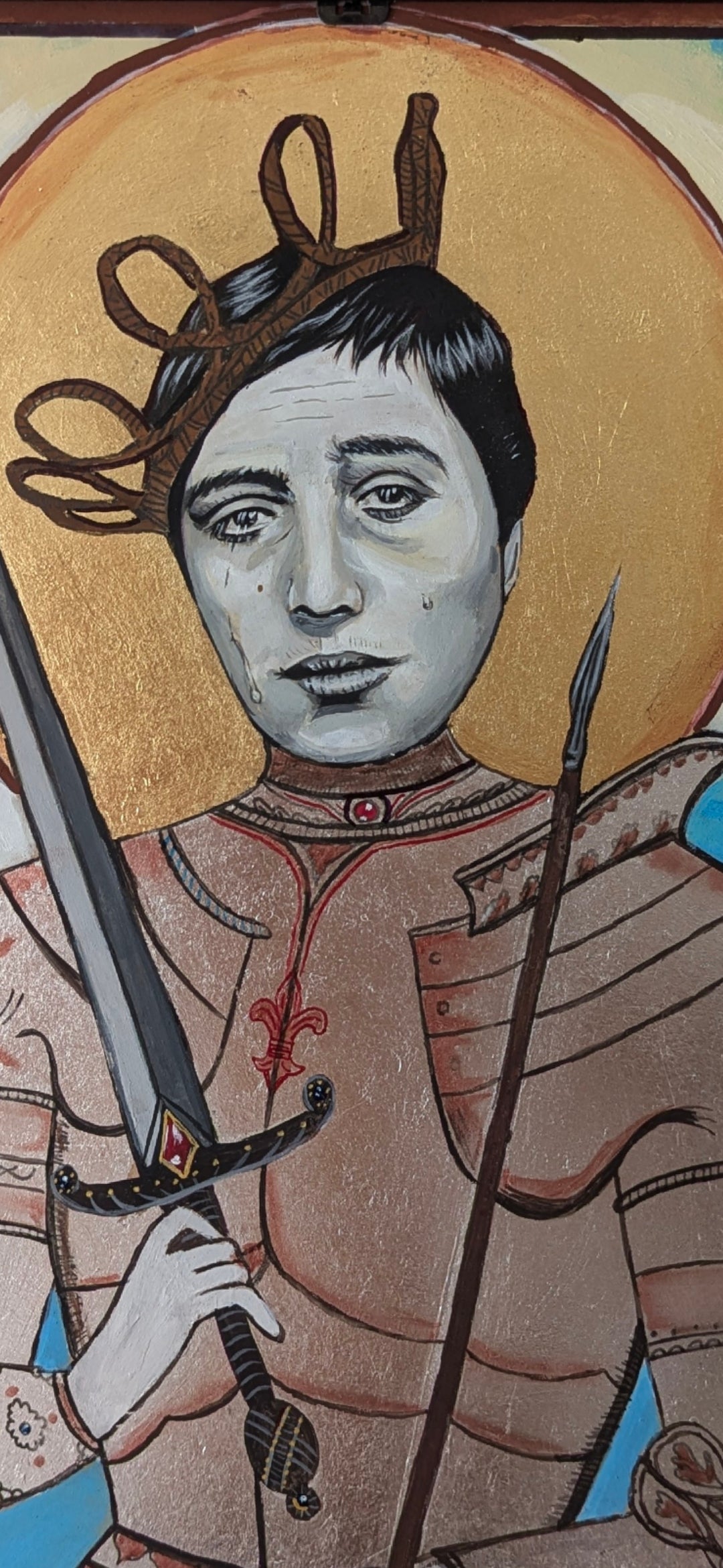 Emotive handcrafted icon of Saint Joan of Arc with burnished gold leaf, reflective silver armor, and expression drawn from Falconetti’s legendary silent film performance