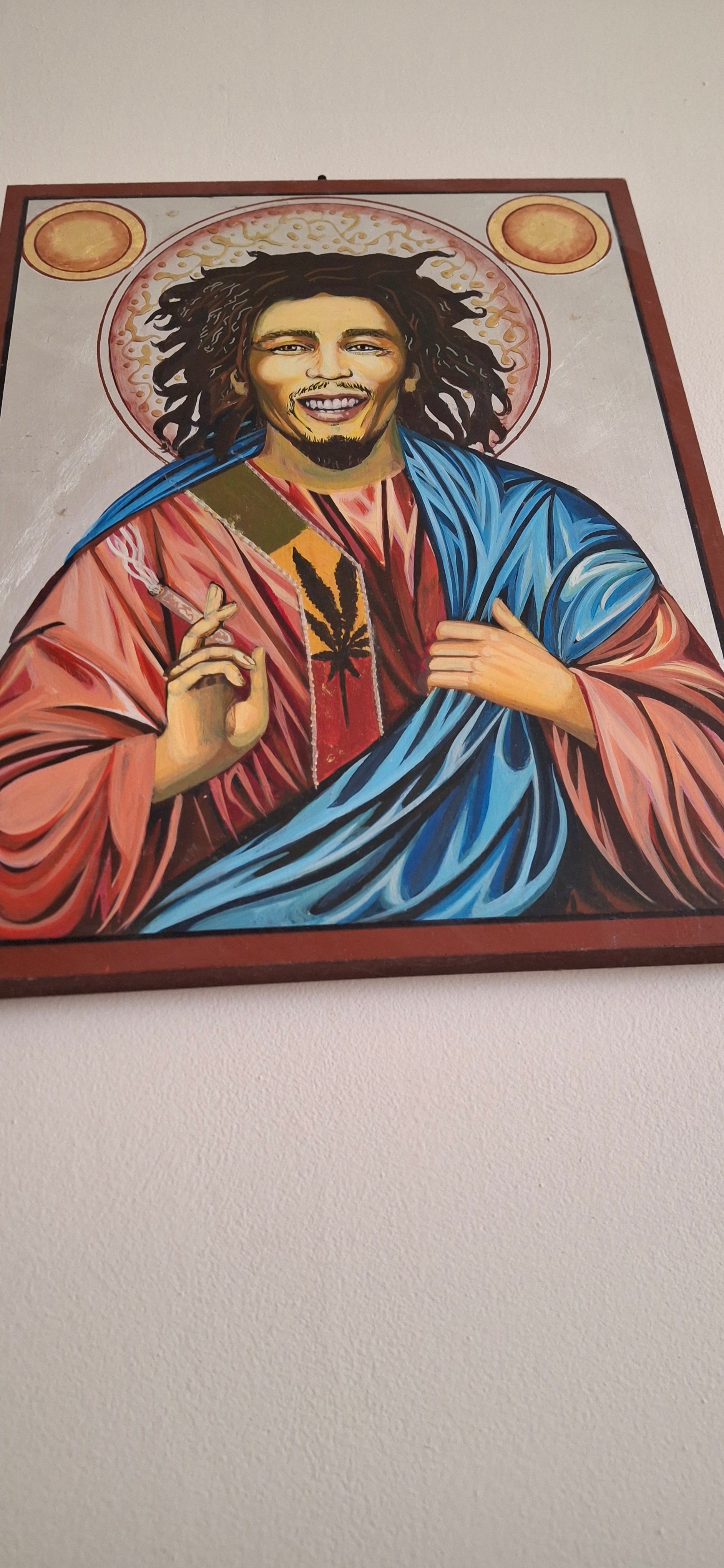 Bob Marley anti-icon in neo-Byzantine style, with sacred light breaking through fractured urban graffiti and Rasta scripture